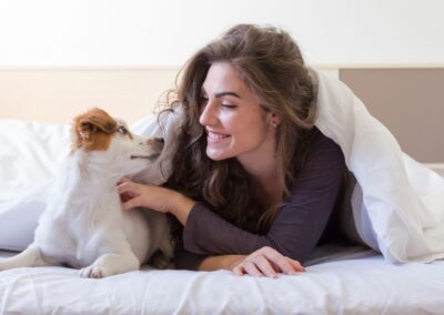 Woman and dog on bed