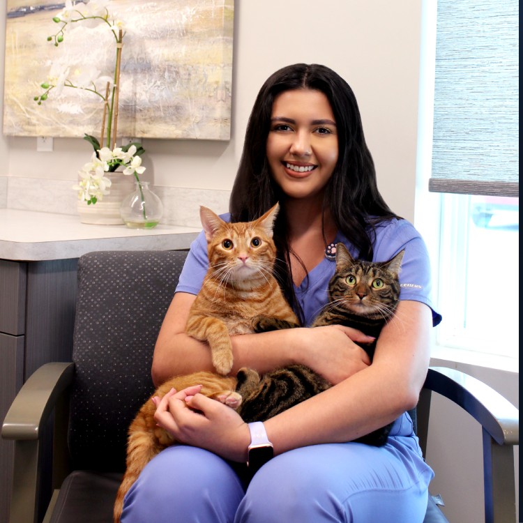 Melanie - Technician women sitting holding pets